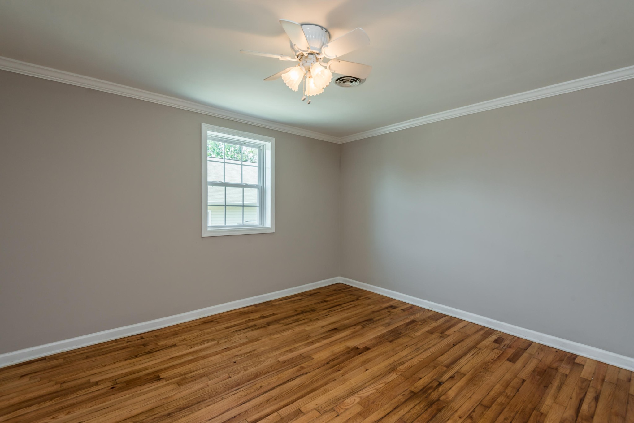 1460 Center Street Alcoa, TN 37701 - Photo 12 of 23 a view of a room with wooden floor and a ceiling fan