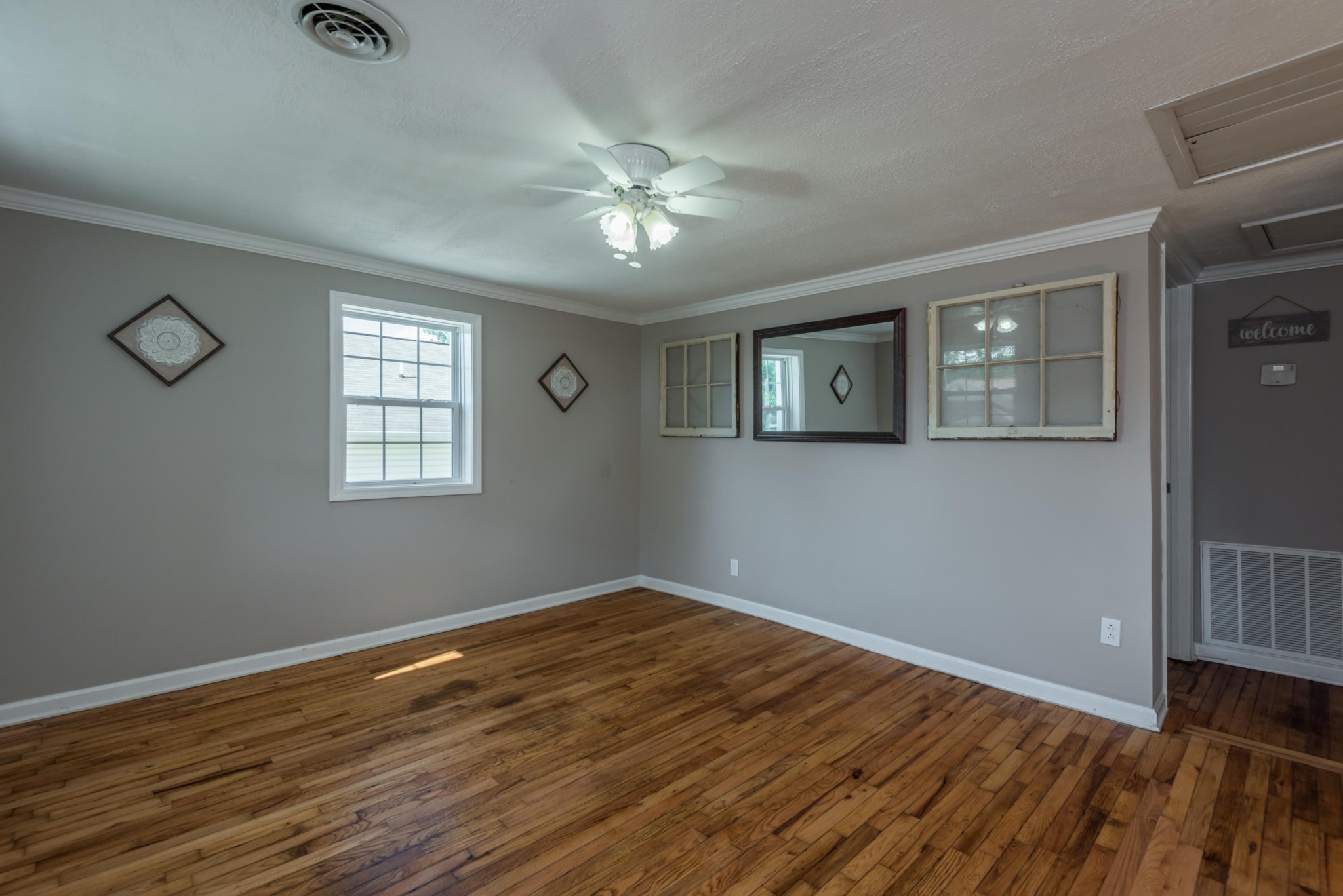 1460 Center Street Alcoa, TN 37701 - Photo 5 of 23 a view of empty room with wooden floor and fan