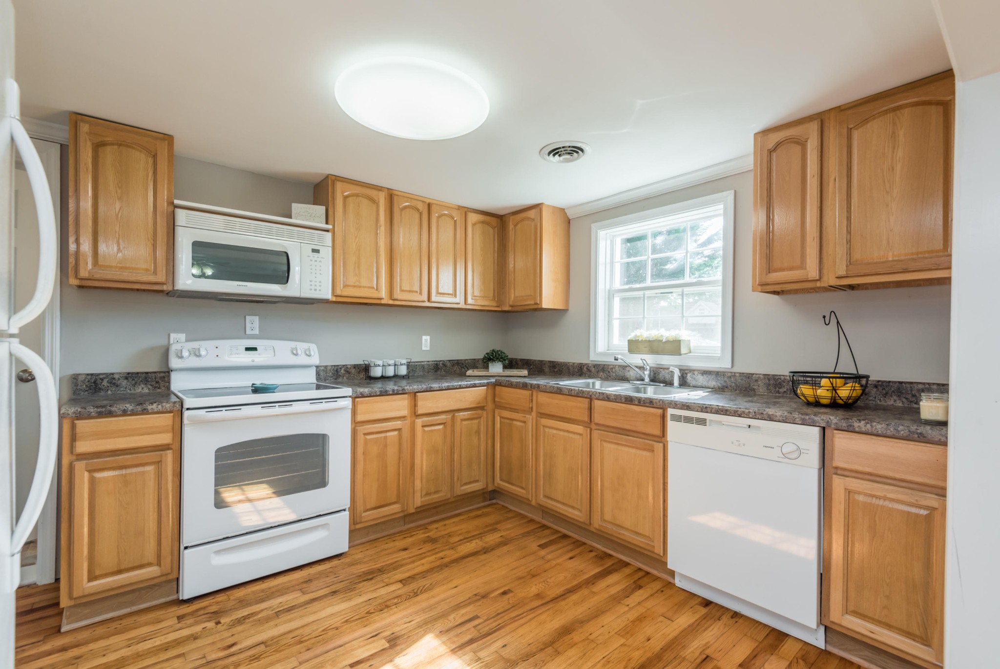 1460 Center Street Alcoa, TN 37701 - Photo 8 of 23 a kitchen with granite countertop wooden cabinets and white appliances