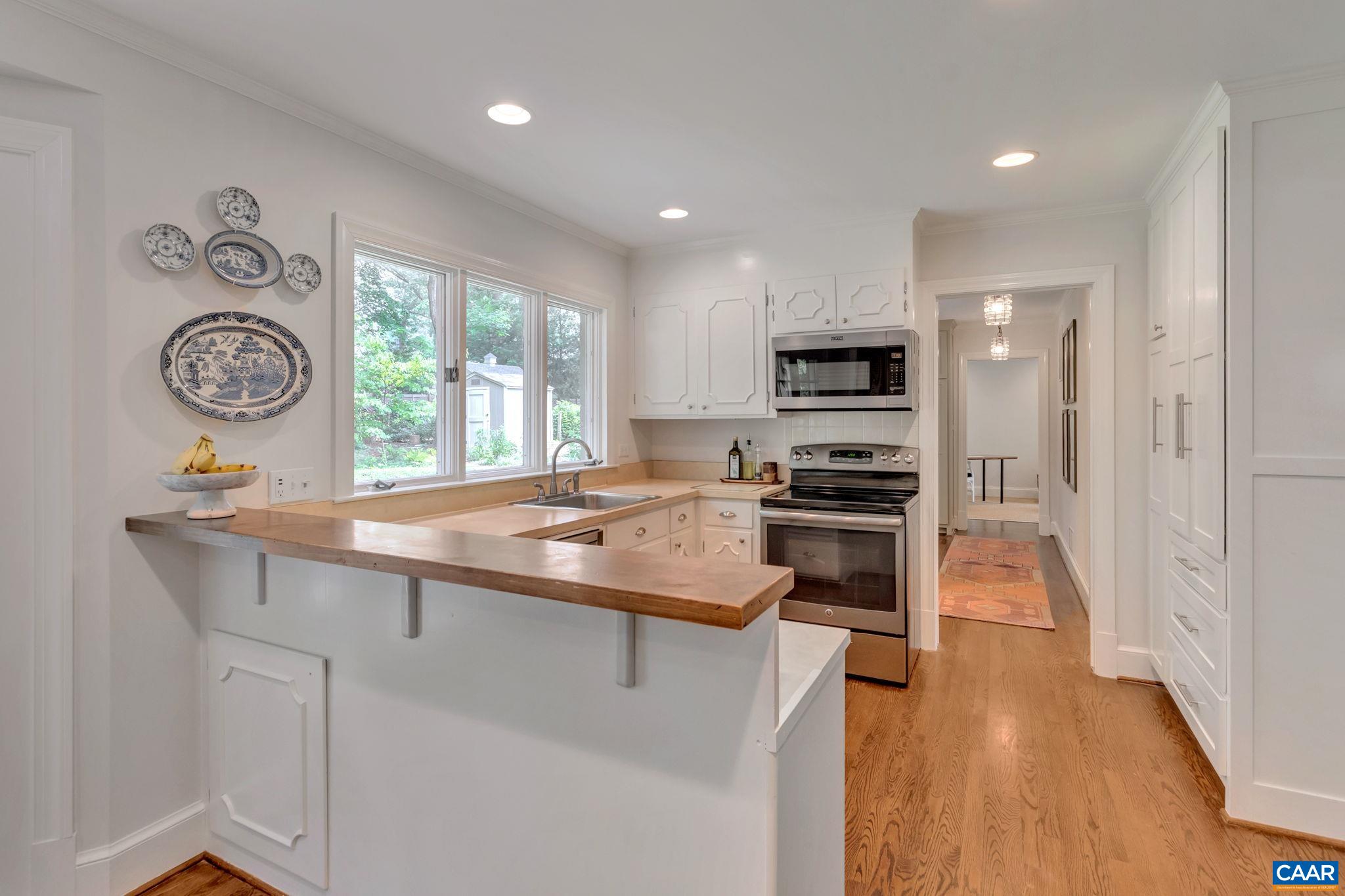 1445 Grove Road Charlottesville, VA 22901 - Photo 14 of 61 a kitchen with a stove a sink and a refrigerator