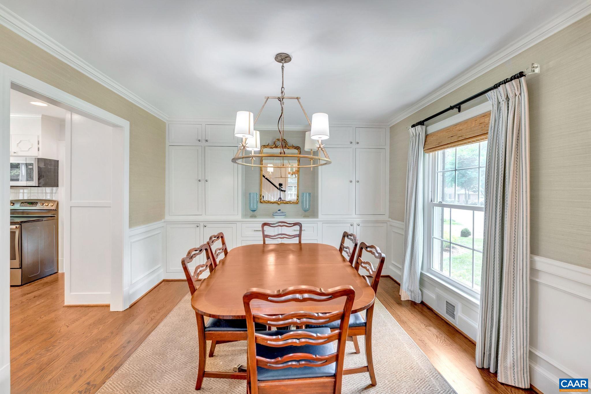1445 Grove Road Charlottesville, VA 22901 - Photo 19 of 61 a dining room with furniture a chandelier and wooden floor