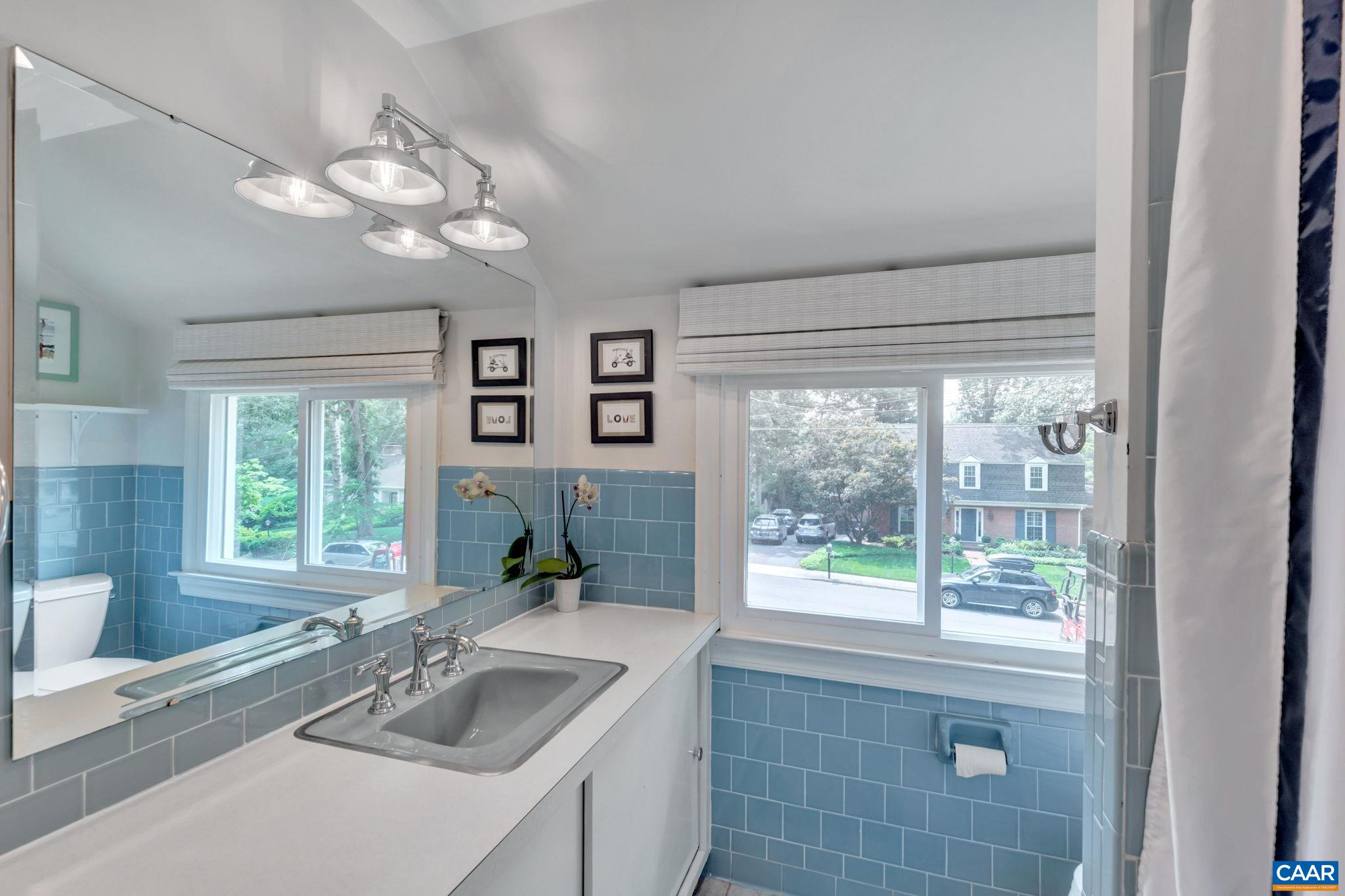 1445 Grove Road Charlottesville, VA 22901 - Photo 40 of 61 a bathroom with a granite countertop sink a large mirror and a large window