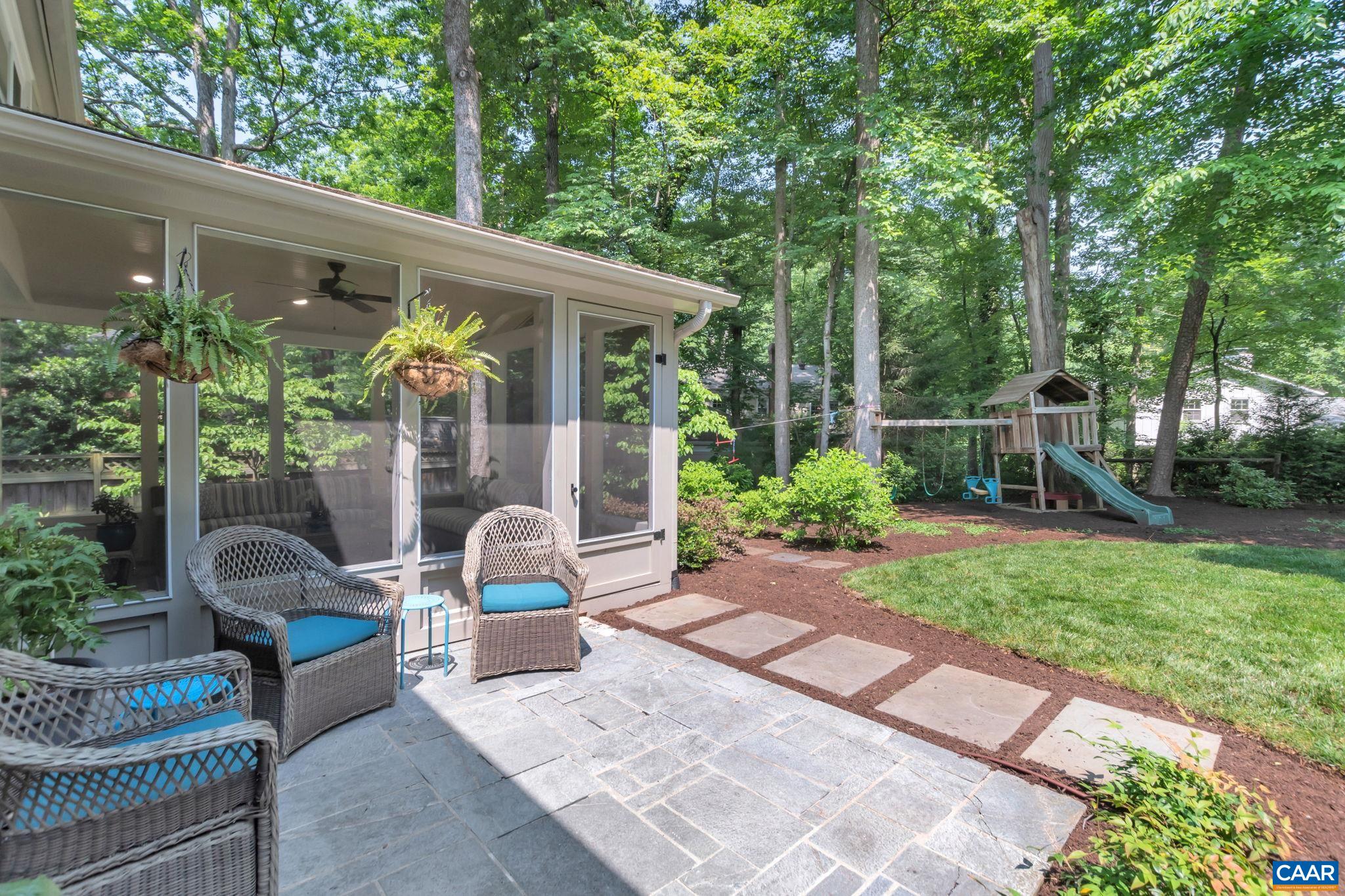 1445 Grove Road Charlottesville, VA 22901 - Photo 48 of 61 a view of a patio with table and chairs potted plants and a large tree