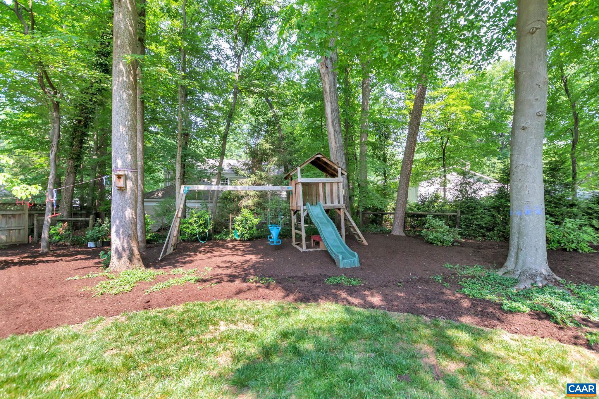 1445 Grove Road Charlottesville, VA 22901 - Photo 53 of 61 a view of a backyard with a slide trees and wooden fence
