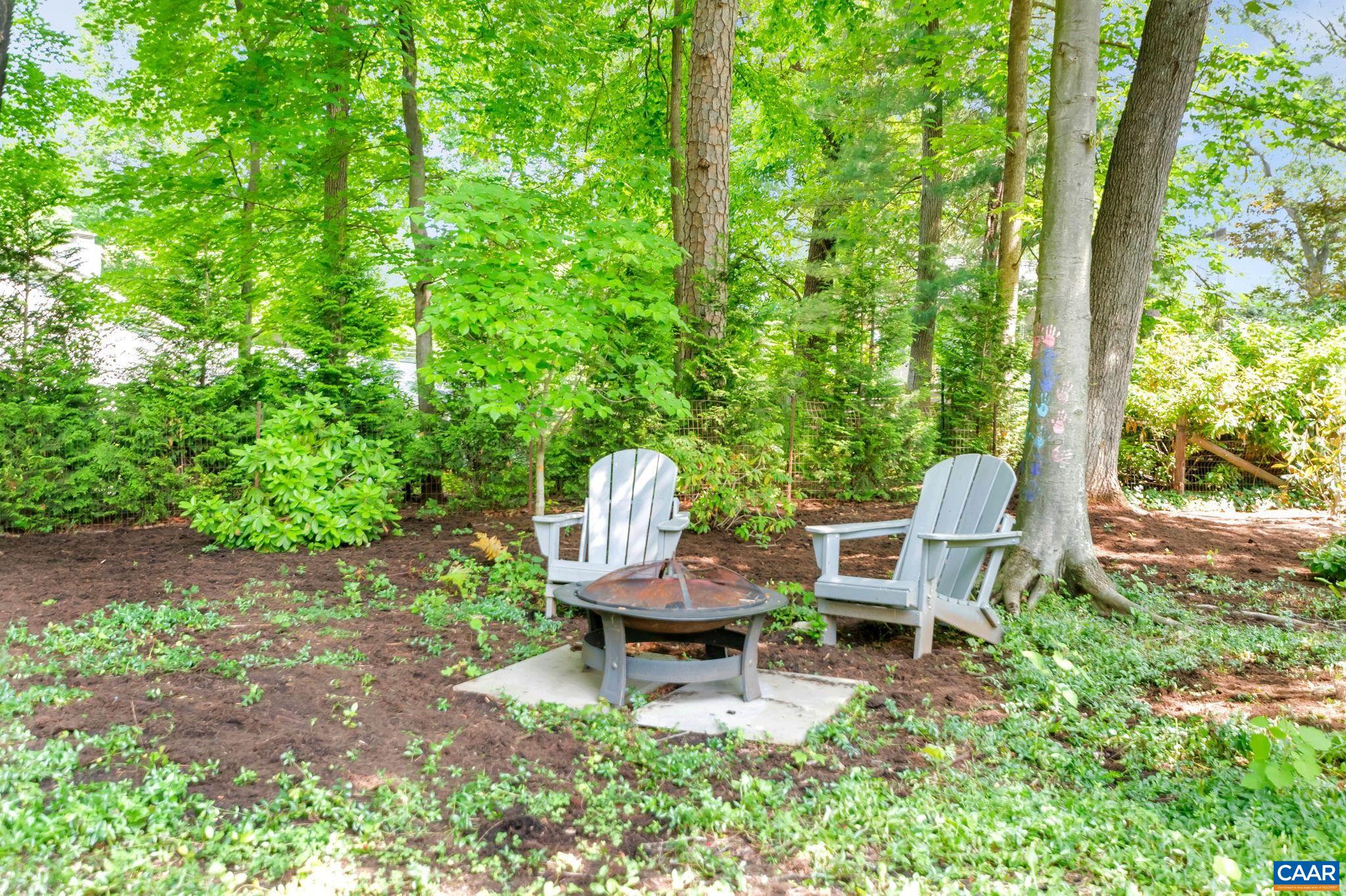 1445 Grove Road Charlottesville, VA 22901 - Photo 54 of 61 a chair and table in a backyard of a house