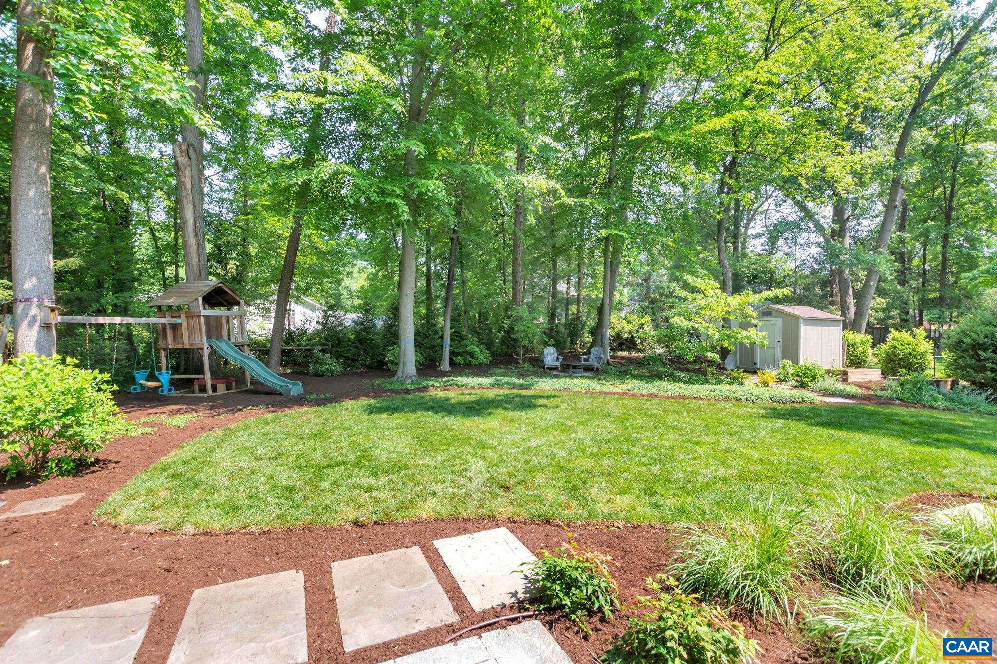 1445 Grove Road Charlottesville, VA 22901 - Photo 59 of 61 a view of a backyard with table and chairs and potted plants and large trees