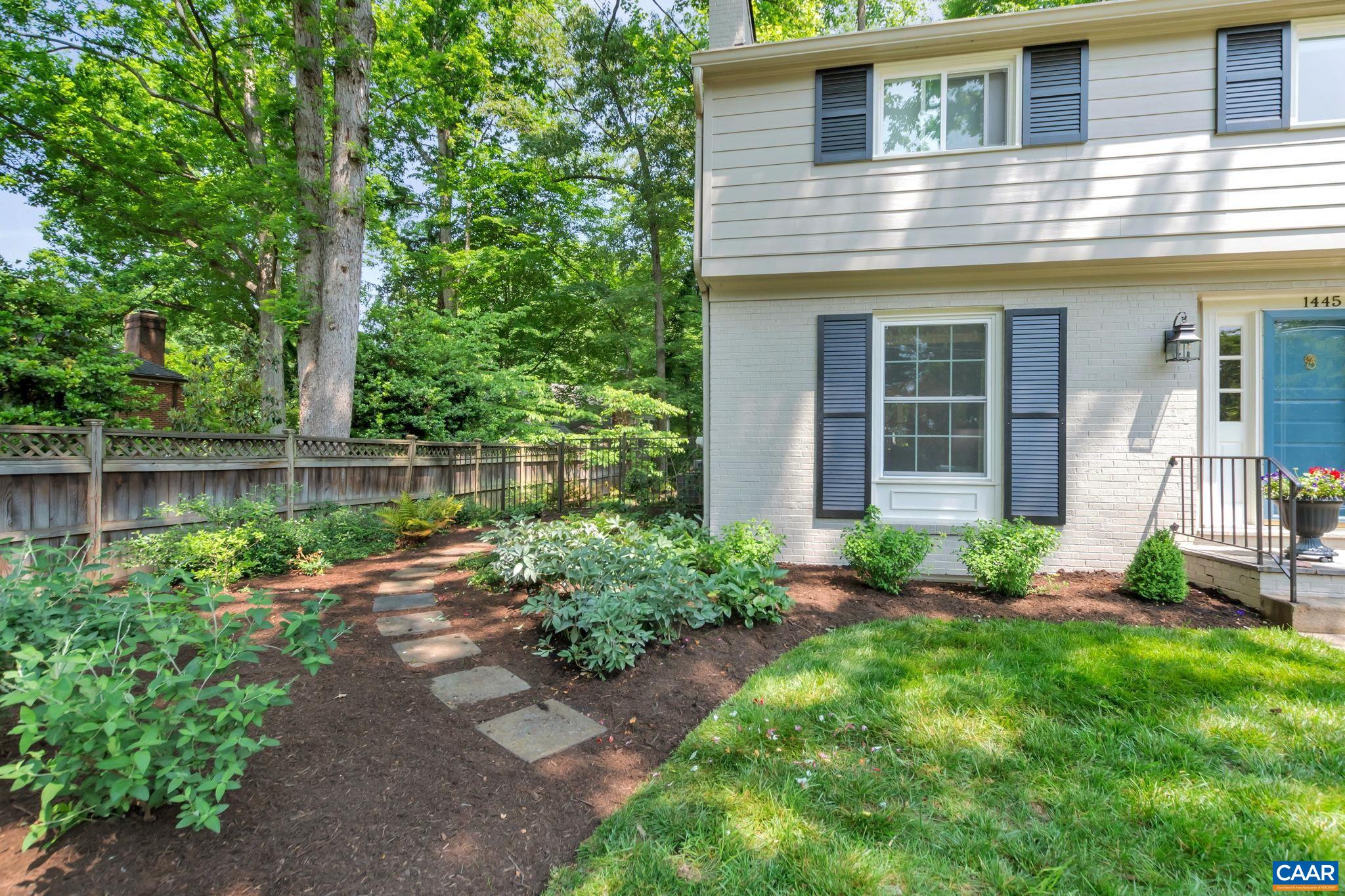 1445 Grove Road Charlottesville, VA 22901 - Photo 60 of 61 a front view of a house with a yard and table and chairs in porch