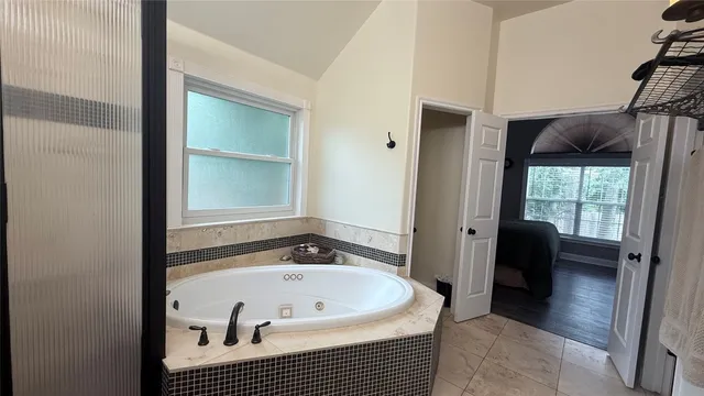 a bathroom with a sink a mirror and a shower