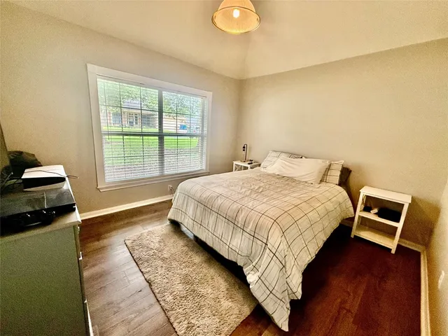 a view of a livingroom with wooden floor and a window