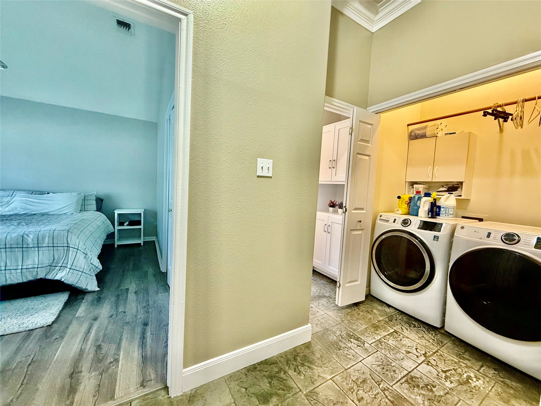 1127 Robin Road Elgin, TX 78621 - Photo 15 of 19 Laundry area with separate washer and dryer, crown molding, cabinet space, and a towering ceiling