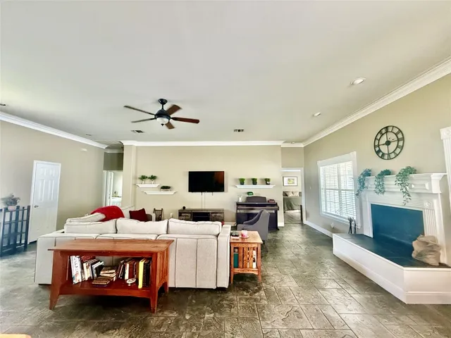 a living room with fireplace furniture and a flat screen tv
