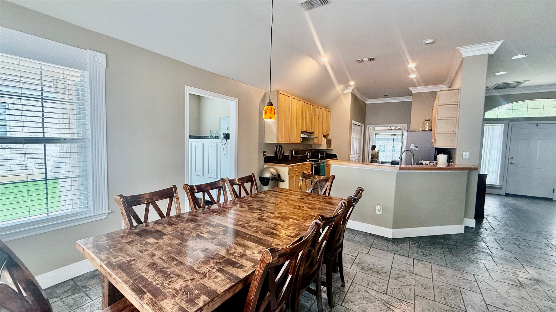 1127 Robin Road Elgin, TX 78621 - Photo 6 of 19 Dining room with plenty of natural light, crown molding, baseboards, and stone tile floors