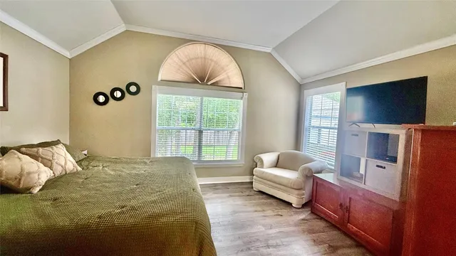 a living room with furniture a large window and a dining table