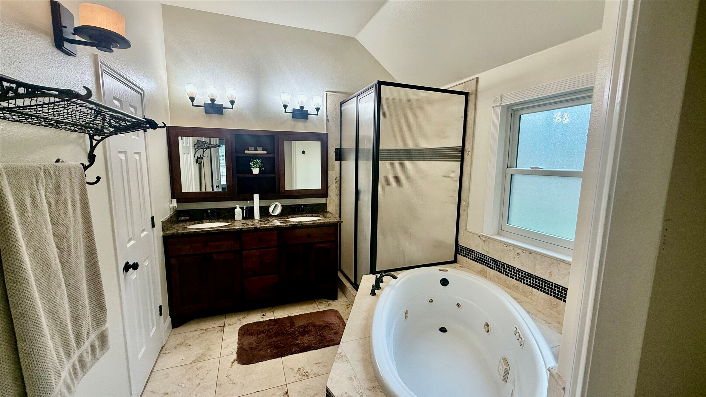 1127 Robin Road Elgin, TX 78621 - Photo 9 of 19 Full bathroom with a stall shower, a jetted tub, double vanity, and vaulted ceiling