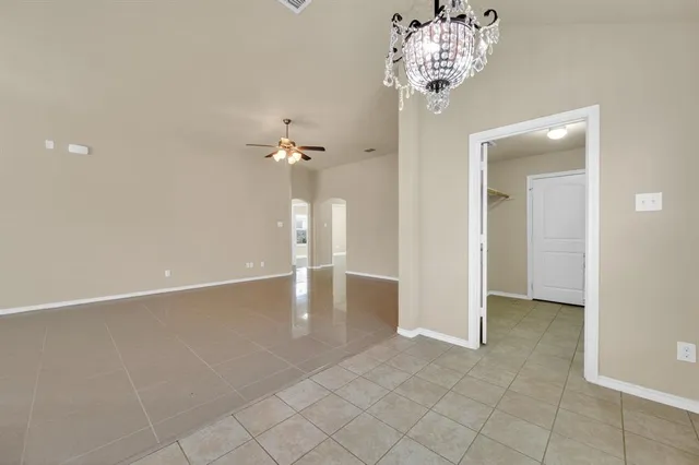 an empty room with kitchen view