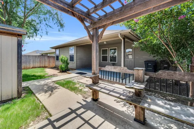 a view of a house with backyard and sitting area