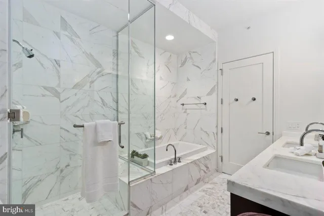a bathroom with a double vanity sink mirror and shower