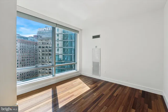 a bedroom with furniture and large window