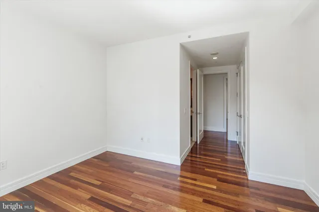 a view of a hallway with wooden shelves