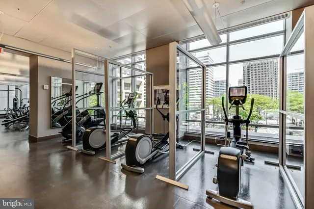 a large room with mirror and windows