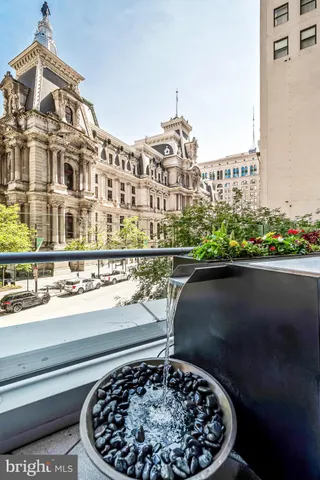 a living room with furniture and floor to ceiling window