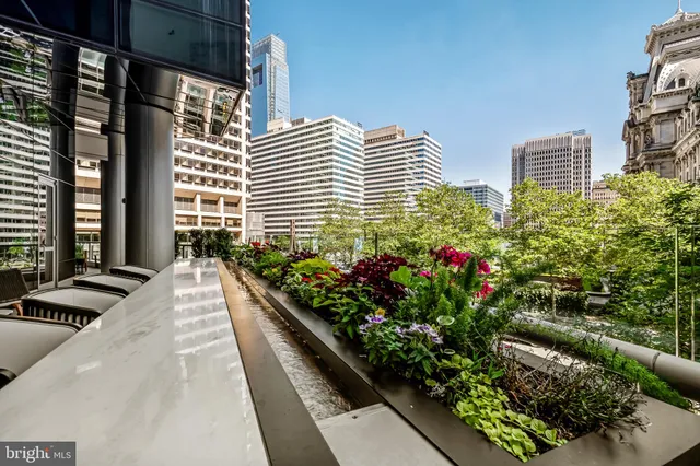 a balcony with wooden floor table and chairs