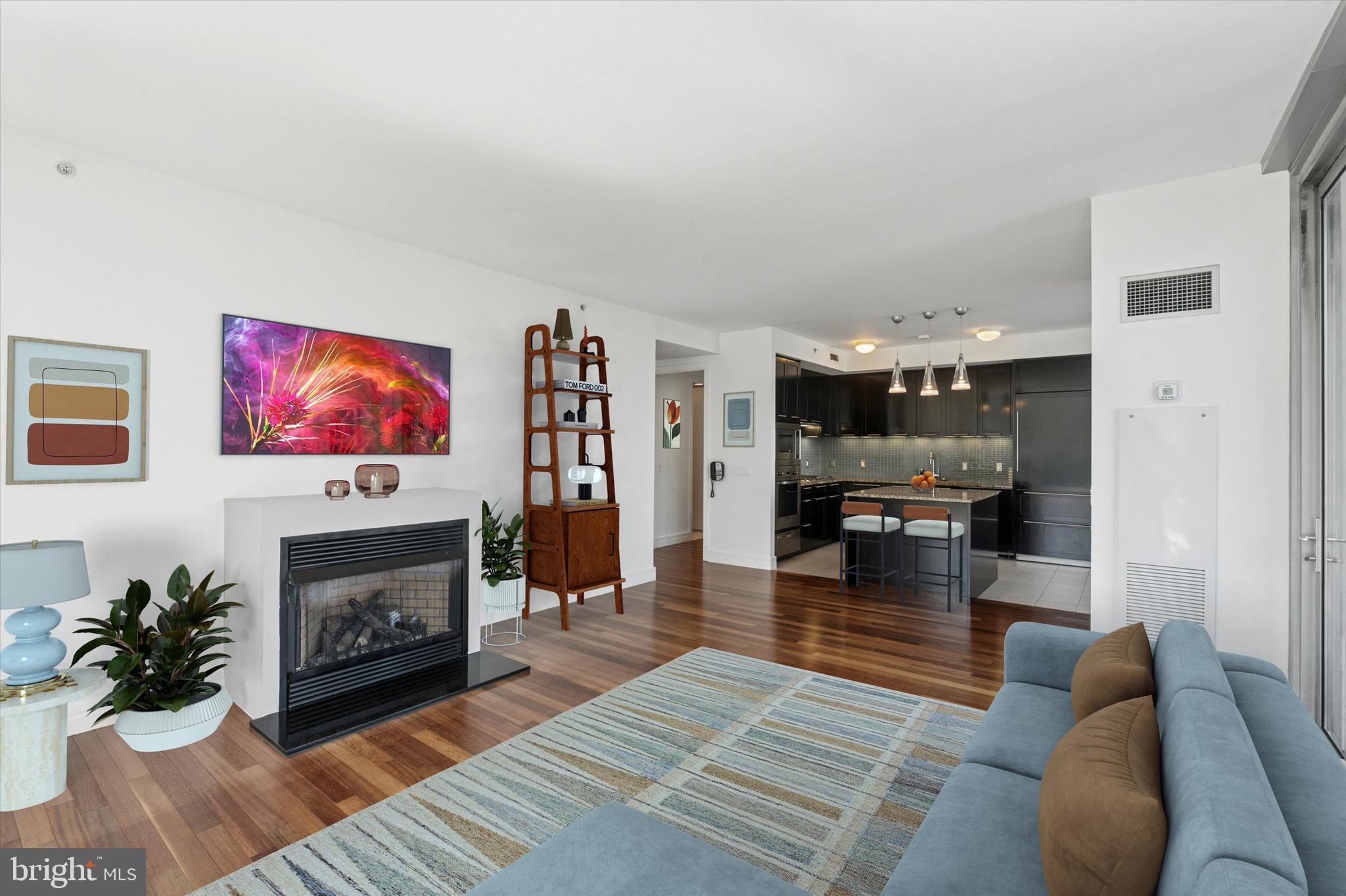 1414 South Penn Square, Unit 18B Philadelphia, PA 19102 - Photo 7 of 52 a living room with furniture a fireplace and a flat screen tv