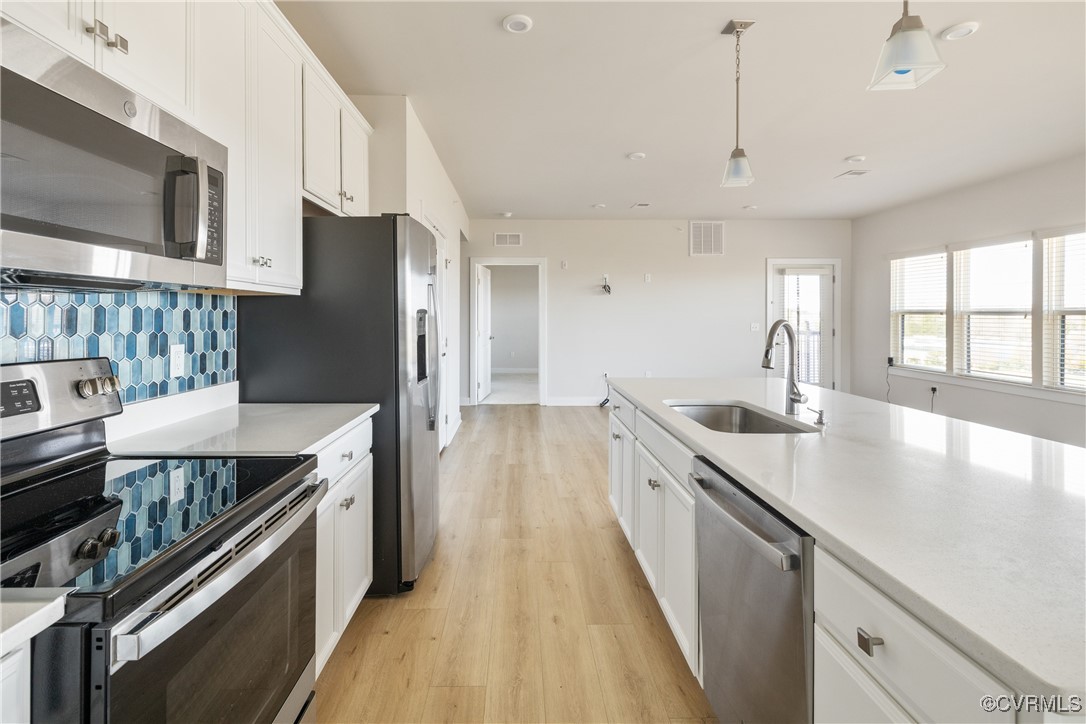 3700 Maze Runner Drive, Unit 405 Midlothian, VA 23112 - Photo 11 of 28 a kitchen with stainless steel appliances granite countertop a sink a stove and a refrigerator