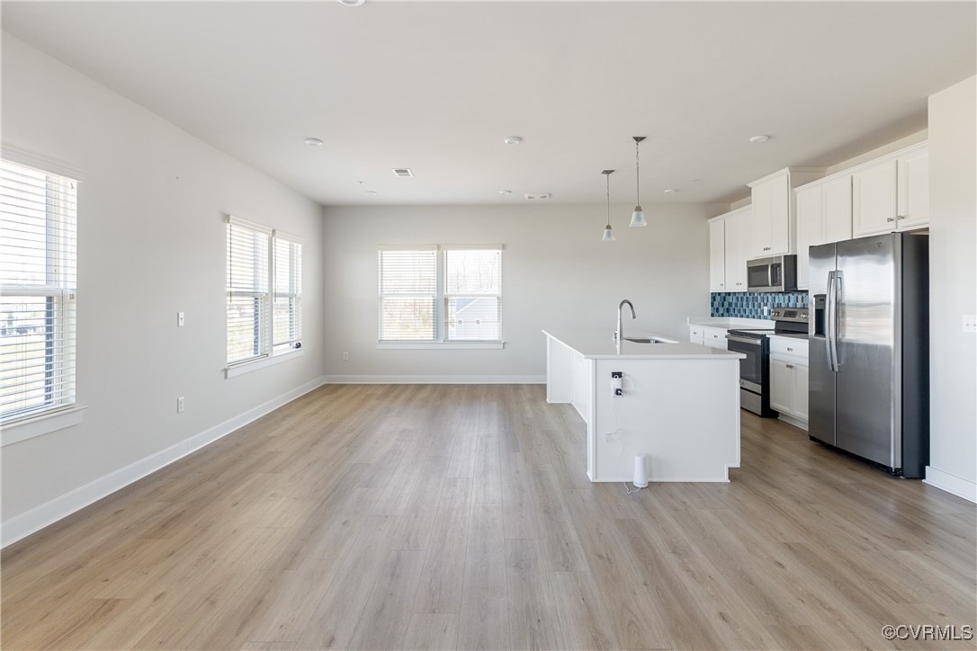 3700 Maze Runner Drive, Unit 405 Midlothian, VA 23112 - Photo 2 of 28 a view of a kitchen with wooden floor electronic appliances and windows