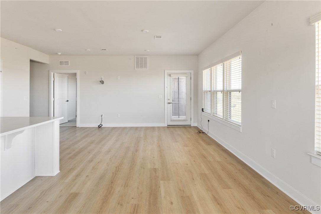 3700 Maze Runner Drive, Unit 405 Midlothian, VA 23112 - Photo 3 of 28 an empty room with wooden floor and windows