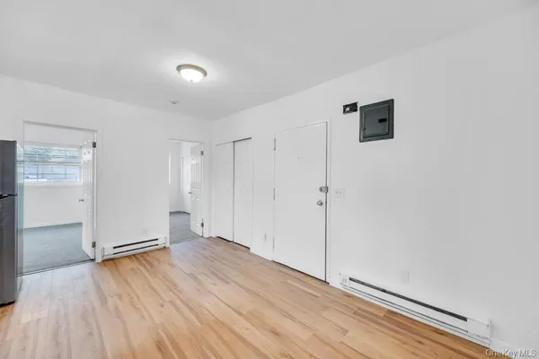 a view of an empty room with wooden floor