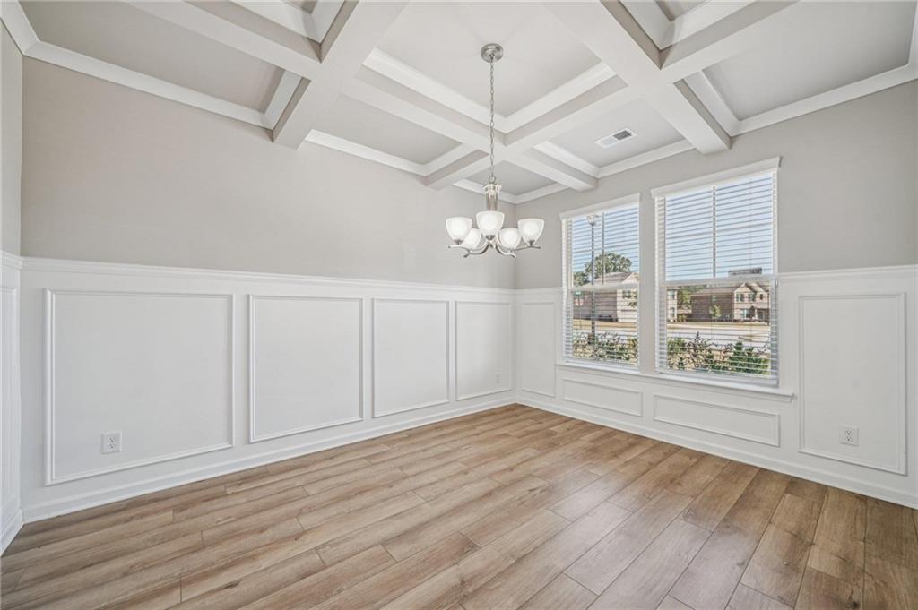 120 Cabin Way Hampton, GA 30228 - Photo 16 of 51 a view of an empty room with a window and wooden floor