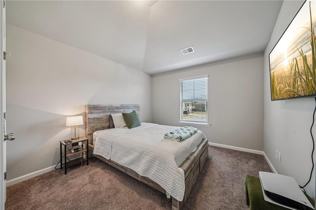 120 Cabin Way Hampton, GA 30228 - Photo 21 of 51 a bedroom with a bed and a window