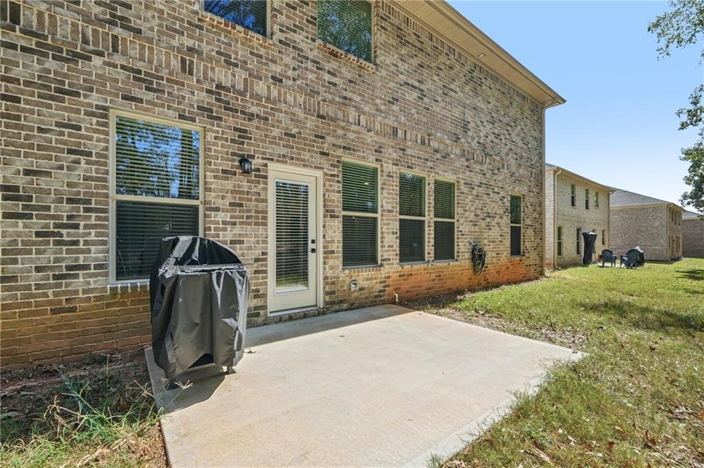 120 Cabin Way Hampton, GA 30228 - Photo 33 of 51 a view of backyard with wheel chair potted plants and floor to ceiling window