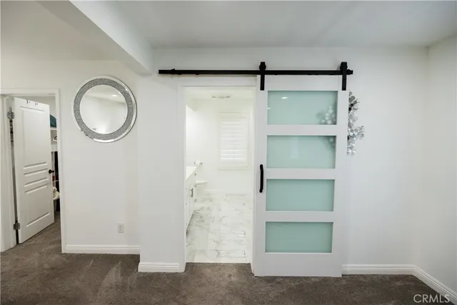 a bathroom with a sink a toilet and mirror
