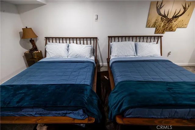 a bedroom with two beds and a couch