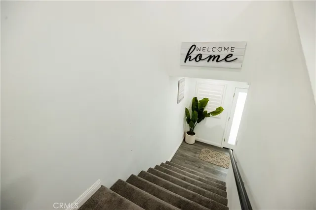 a view of entryway with stairs and wooden floor