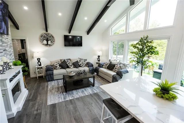 a living room with patio furniture and a large window