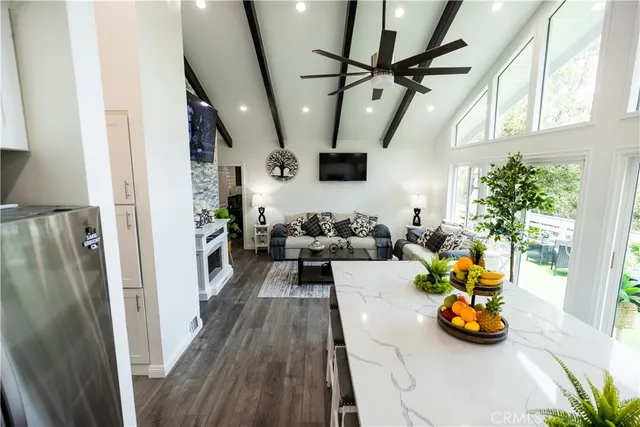 a kitchen with a sink a refrigerator and cabinets