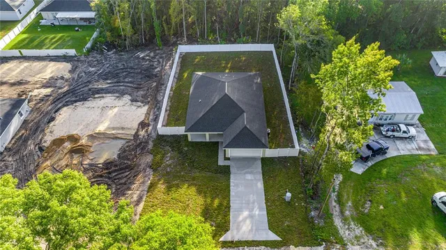 an aerial view of a house with a yard