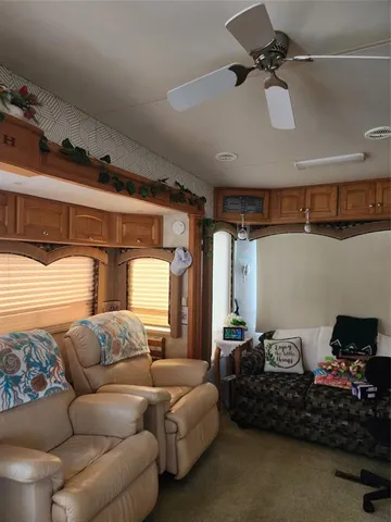a living room with furniture and a ceiling fan