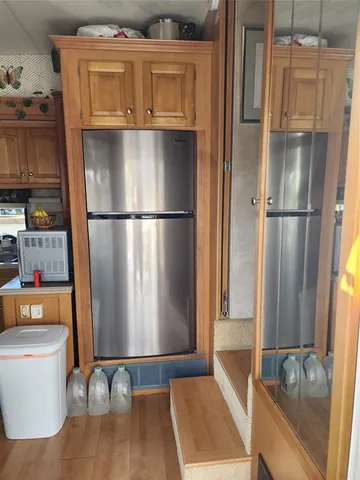 a kitchen with stainless steel appliances granite countertop a refrigerator and a stove