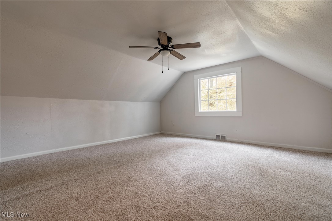 1931 Bridger Road Akron, OH 44312 - Photo 33 of 40 Bonus room with a textured ceiling, ceiling fan, carpet flooring, and vaulted ceiling
