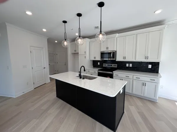 a kitchen with a sink and a refrigerator