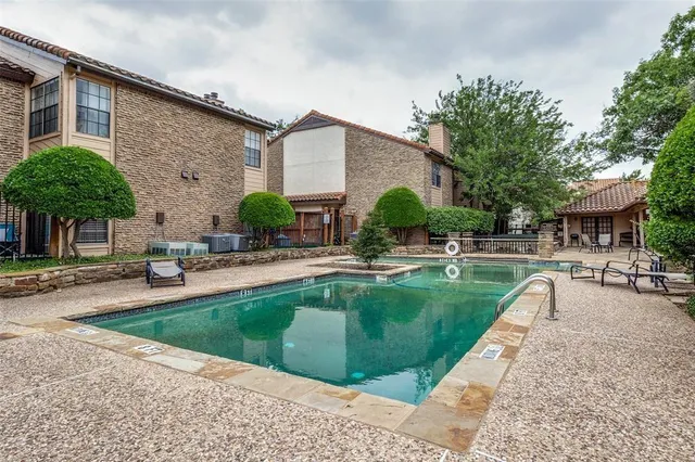 a swimming pool with outdoor seating and yard