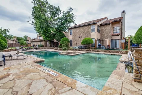 a swimming pool with outdoor seating and yard