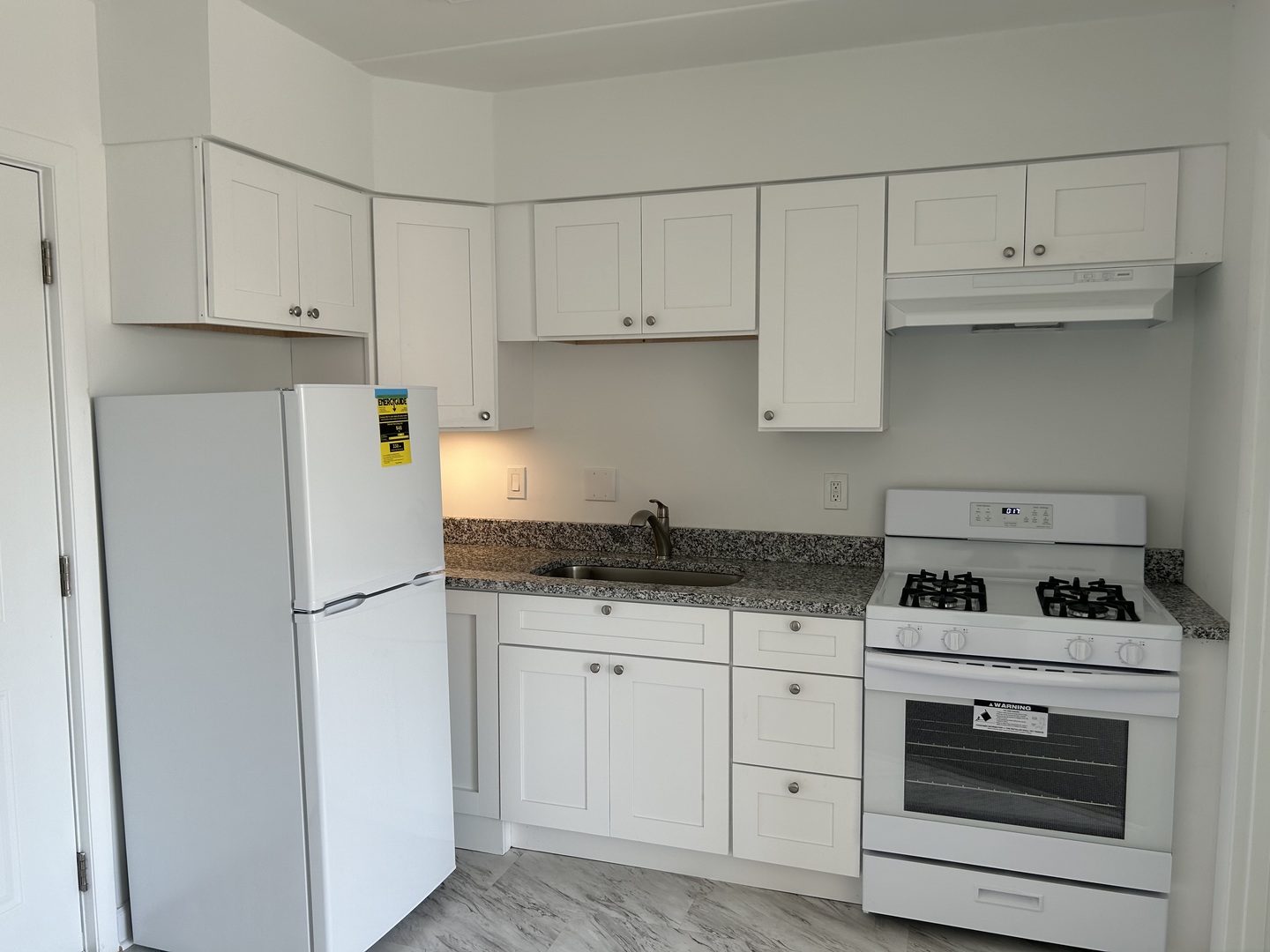 2825 Ridgeland Avenue, Unit 10 Berwyn, IL 60402 - Photo 4 of 10 a kitchen with granite countertop white cabinets and white appliances