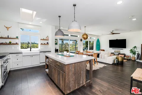 a kitchen with counter space and wooden floor