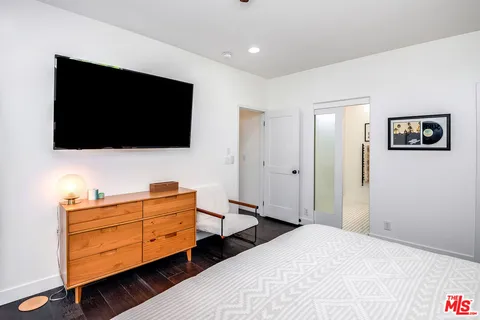 a bathroom with a double vanity sink a mirror a shower and a bathtub