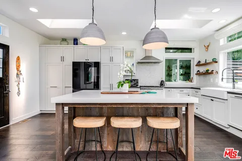 a kitchen with a table and chairs in it
